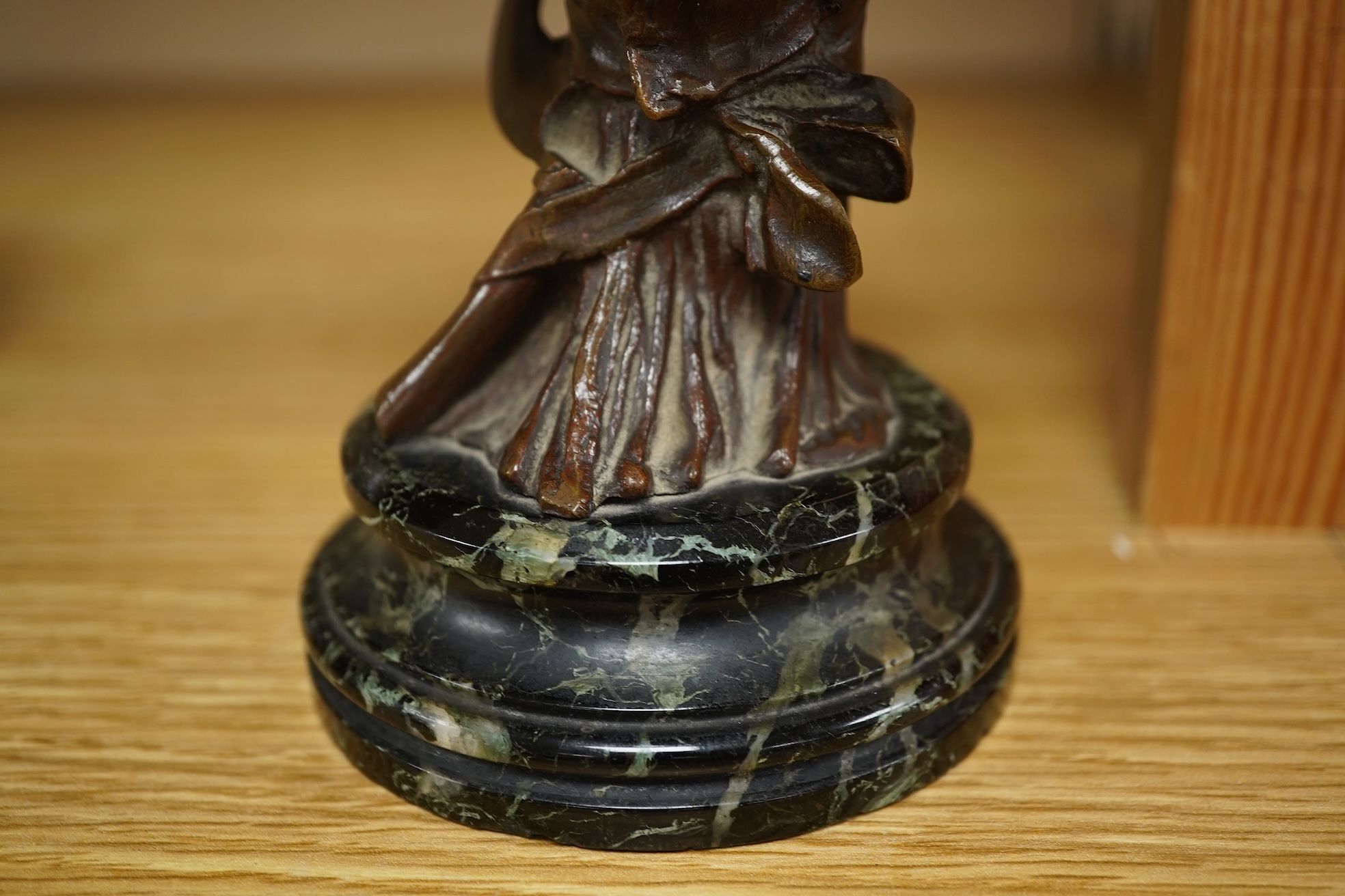 A late 19th century bronze bust of a lady in a hat with floral decoration , mounted on marble, signed, 21.5cm high.